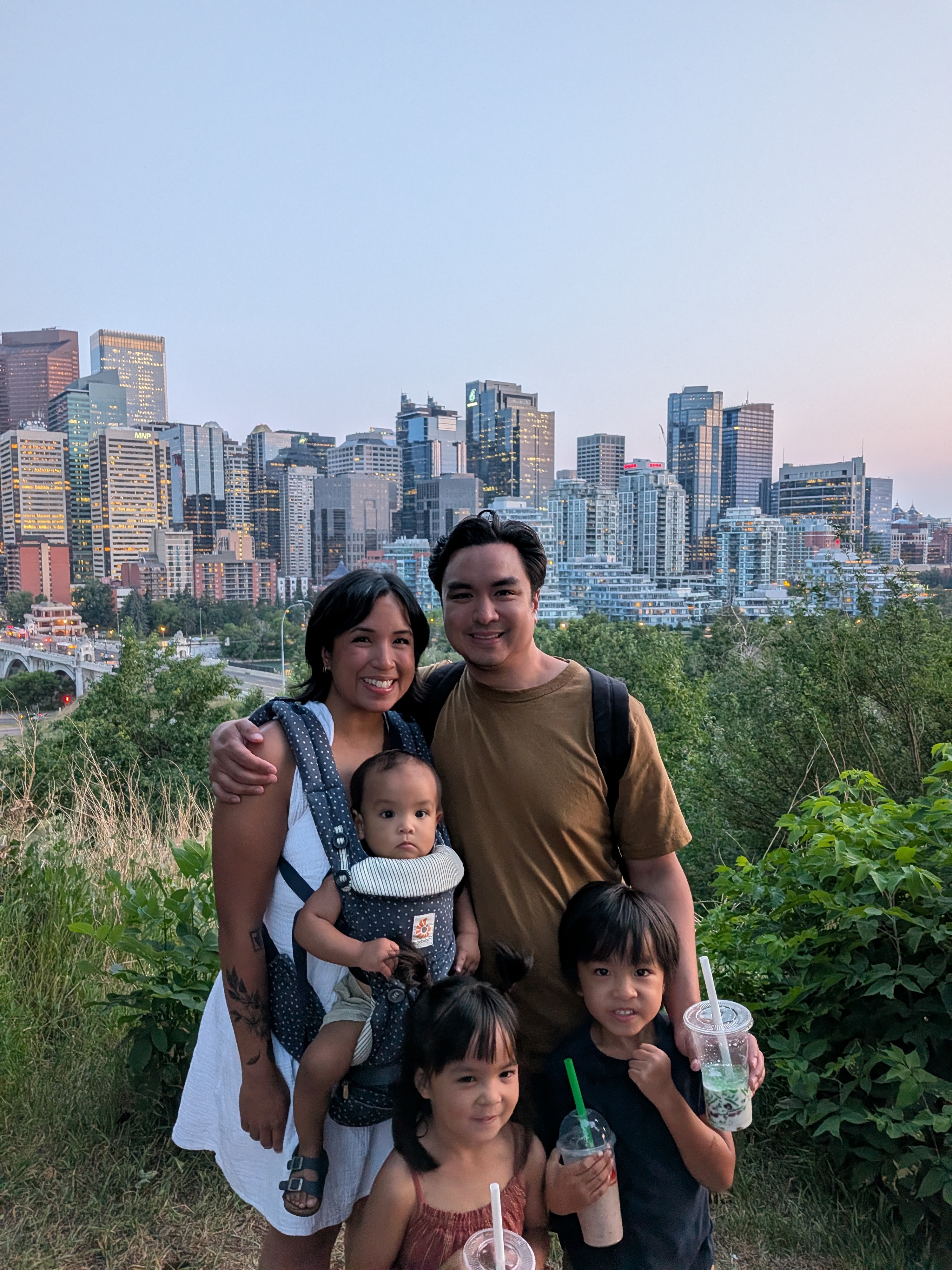 Gary and his family on a hillside above the Calgary skyline at dusk