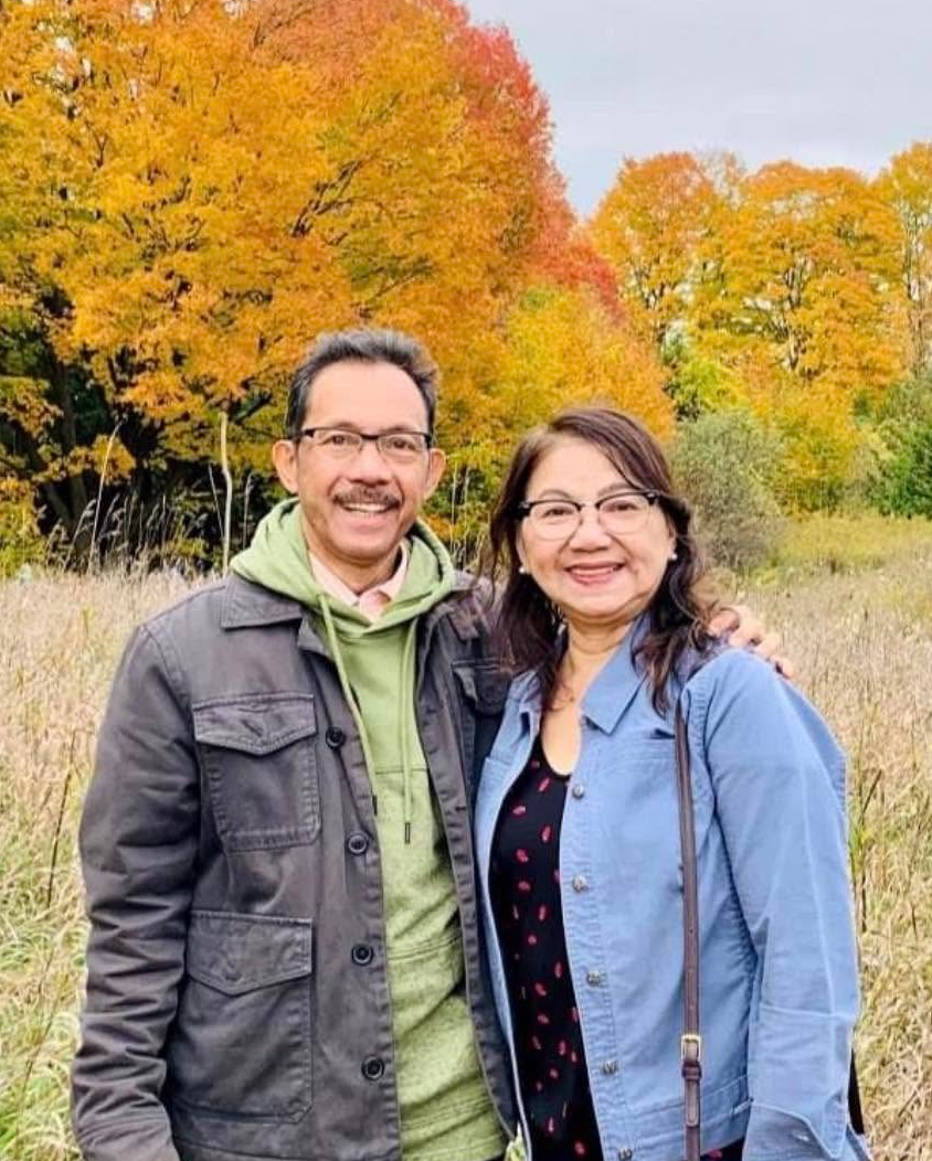 Rudy and his wife outdoors in autumn